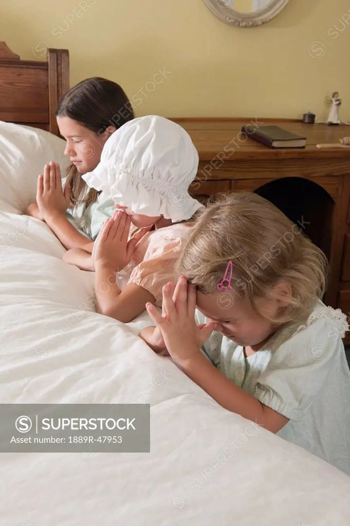 Three sisters doing their bedtime prayers