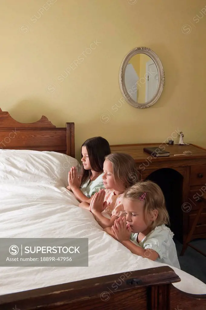Three sisters doing their bedtime prayers