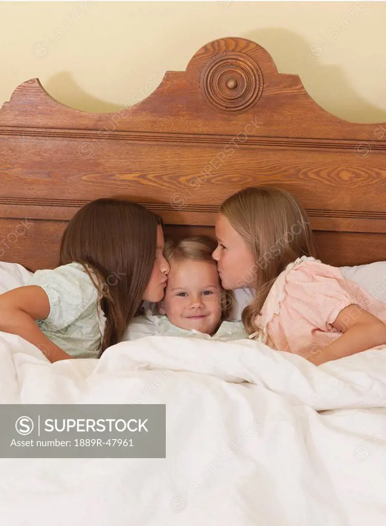 Three young sisters at bedtime