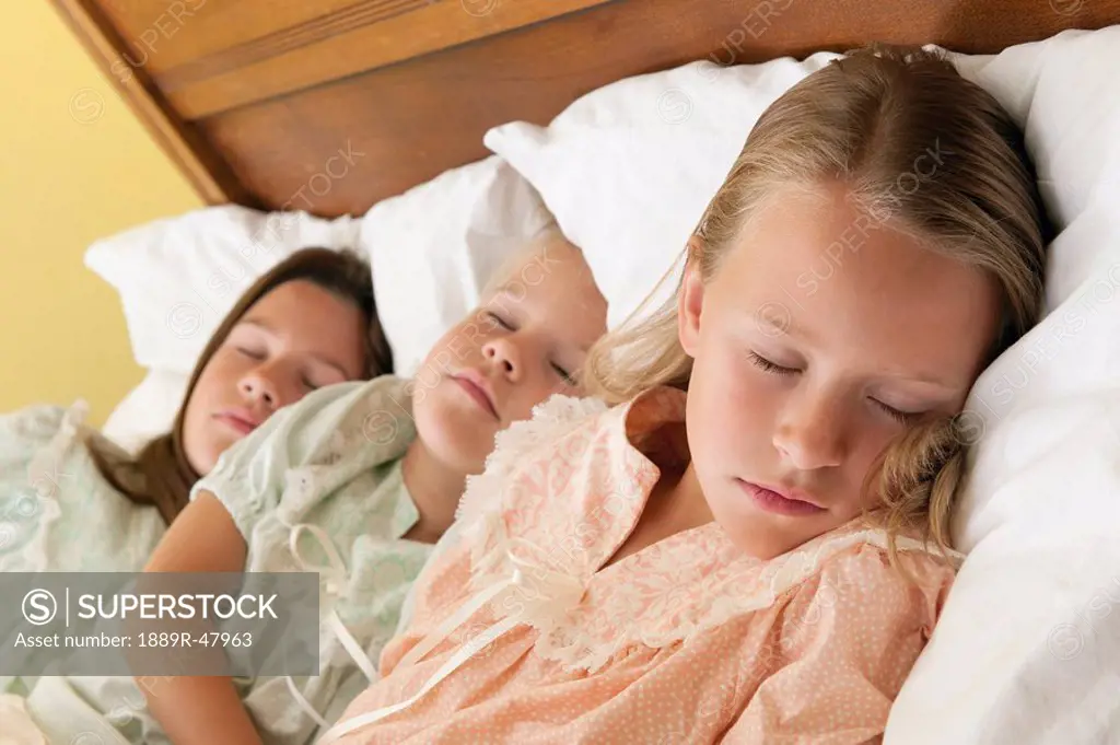 Three young sisters at bedtime