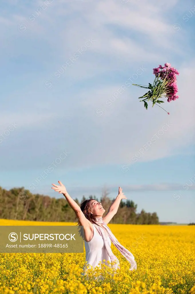 A young woman in a canola field