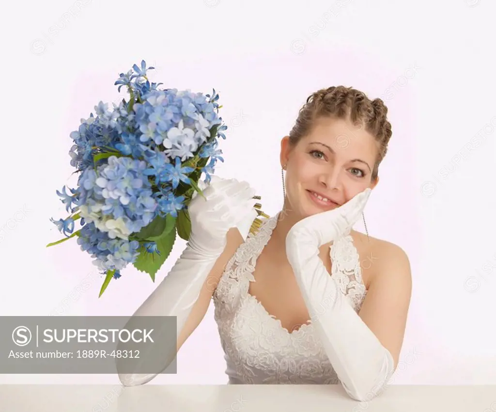 Happy bride holding flowers