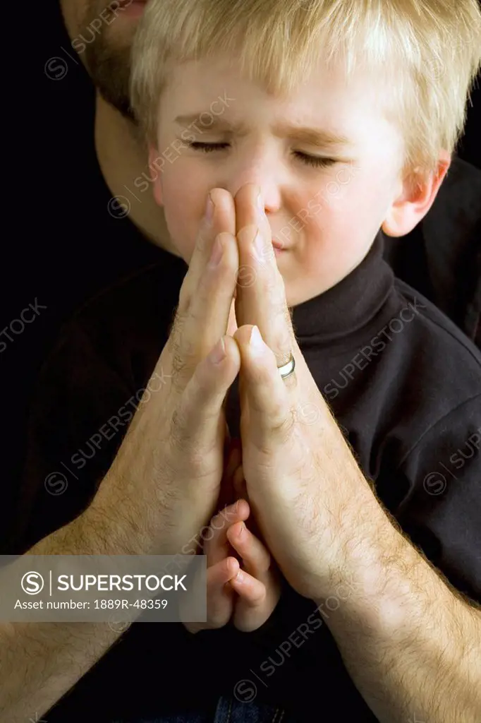 Father praying with son