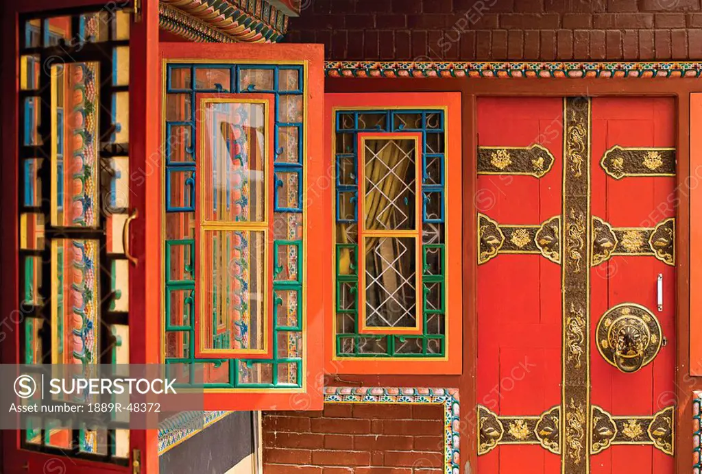 Row of colorful open windows at a Buddhist monastery in Nepal