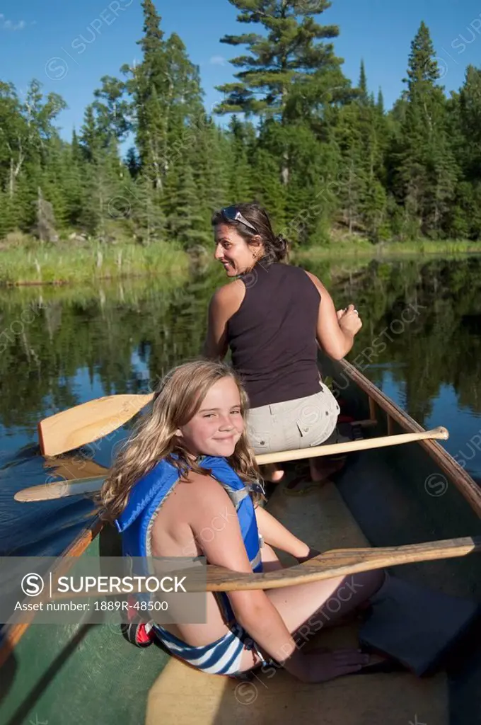 Mother and daughter on a canoe, Lake of the Woods, Ontario, Canada