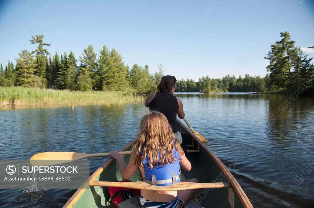 Two people on a canoe, Lake of the Woods, Ontario, Canada