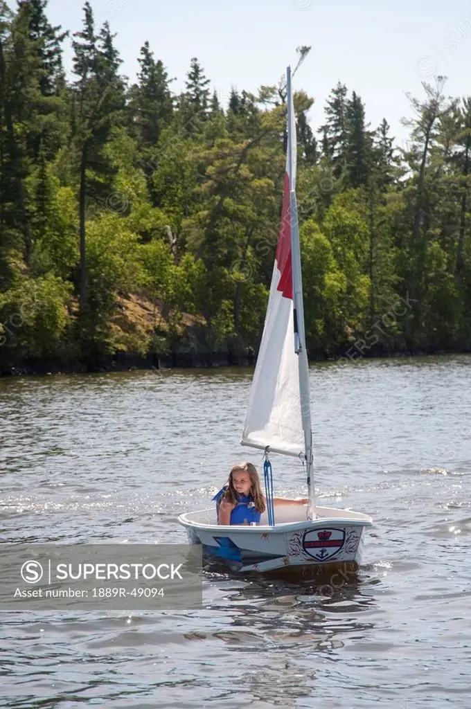Young girl in small boat, Lake of the Woods, Ontario, Canada