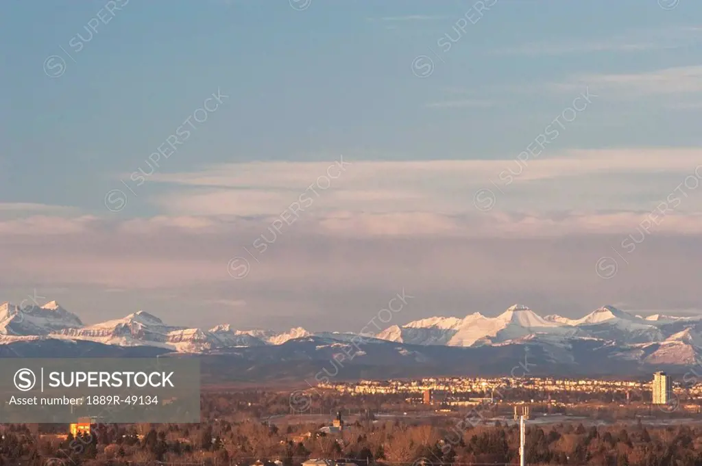 City skyline against mountain backdrop, Calgary, Alberta, Canada