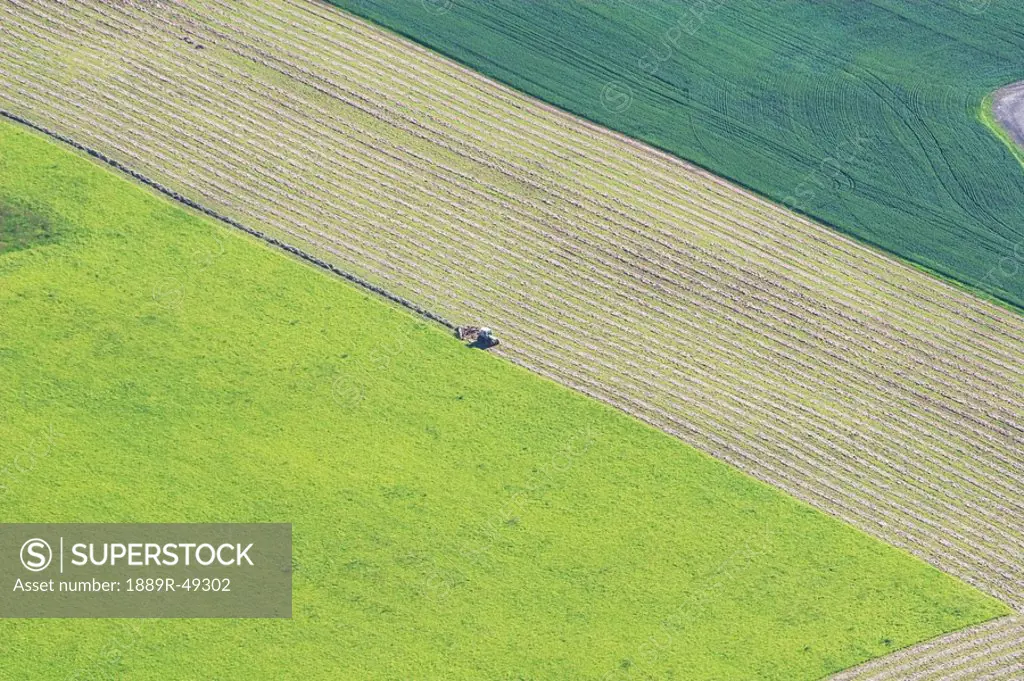 Aerial of tractor harvesting field