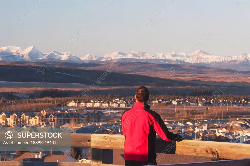 Man looking out over Calgary, Alberta, Canada