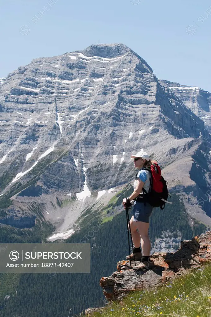 Woman standing on the top of a mountain
