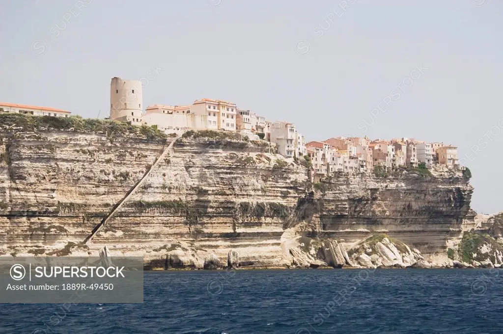 bonifacio, corsica, france, white cliffs along the shoreline and houses on the cliffs