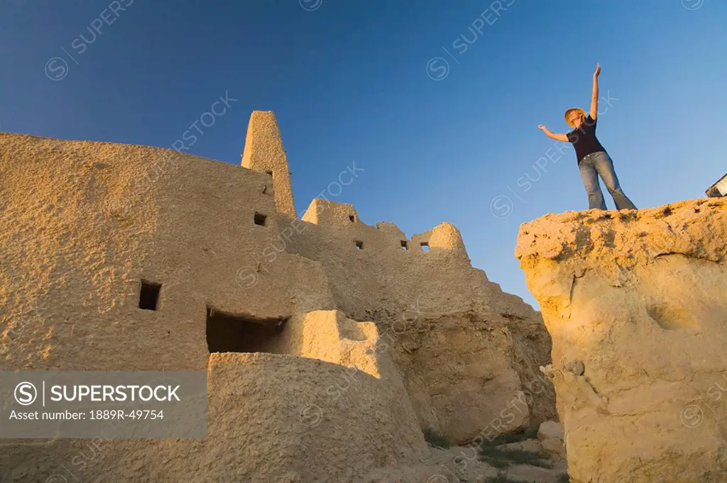 Woman tourist at The Temple of the Oracle Temple of Amun at the Siwa Oasis in Egypt