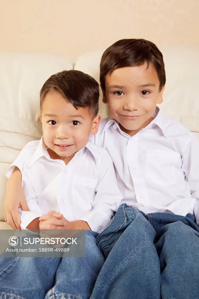 Two boys sitting on a couch