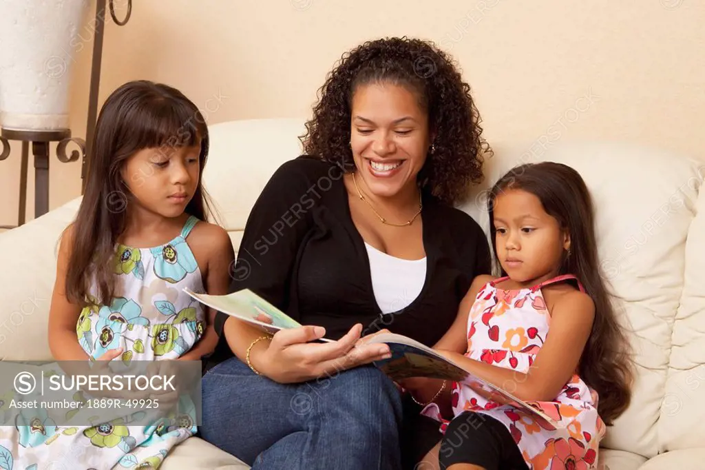 mother reading to her daughters