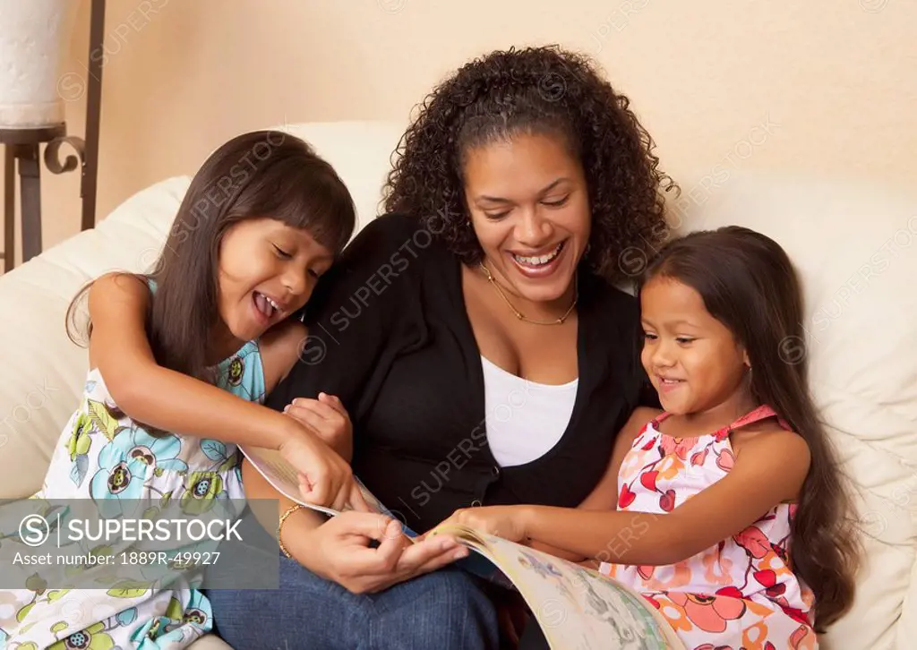 mother reading to her daughters