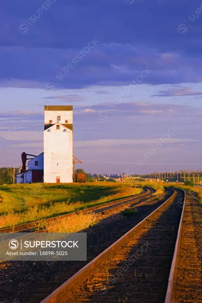 Grain elevator next to railway tracks
