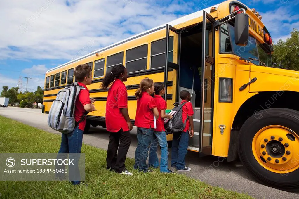 students getting on a school bus