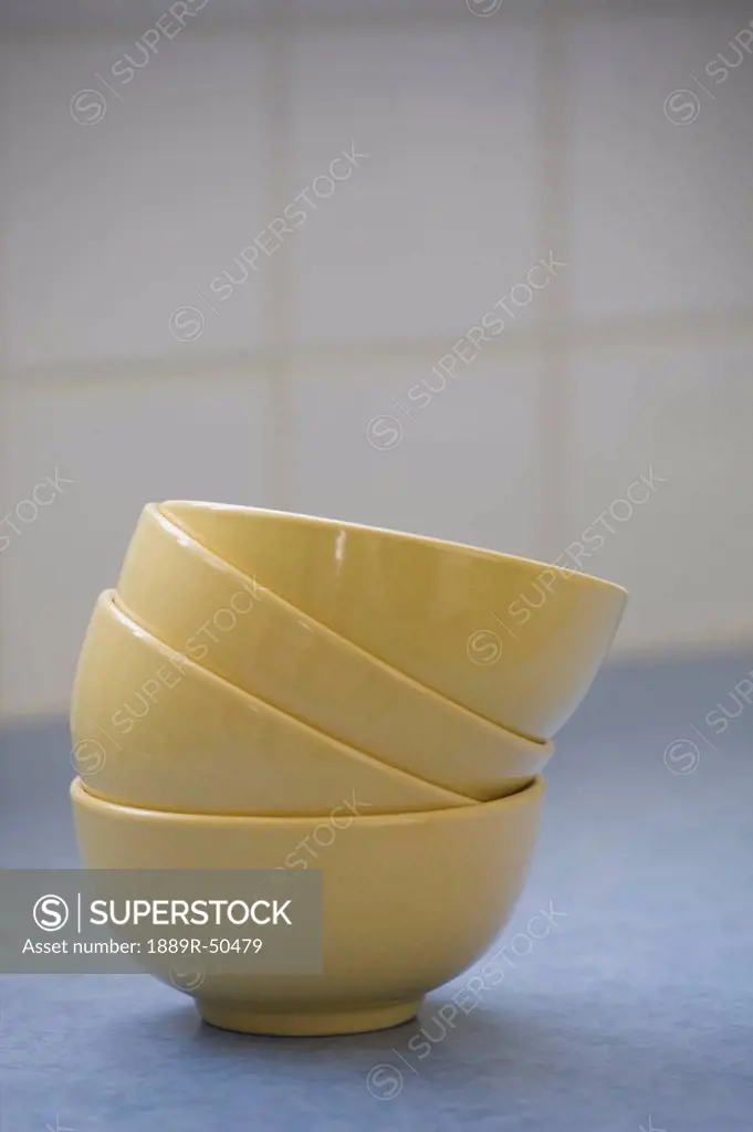 a stack of yellow bowls