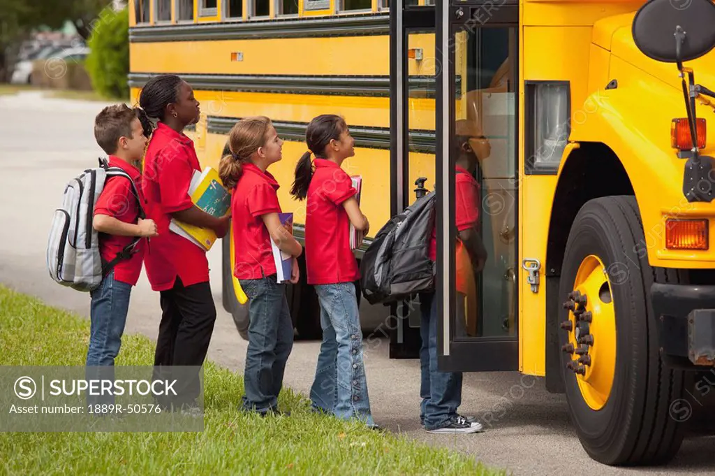 students lined up to get on the school bus