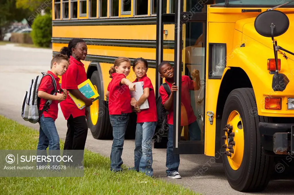 students lined up to get on the school bus