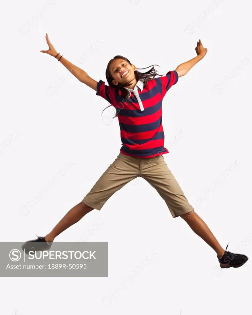 girl jumping with arms and legs outstretched