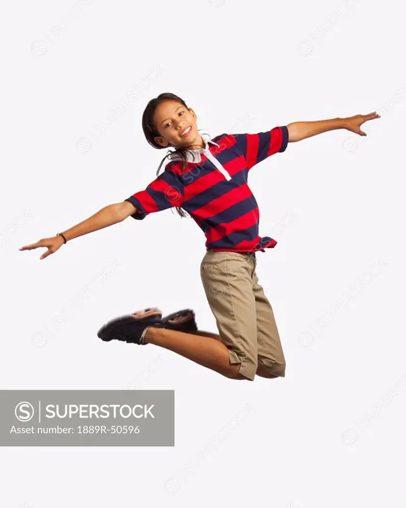 girl jumping with arms outstretched