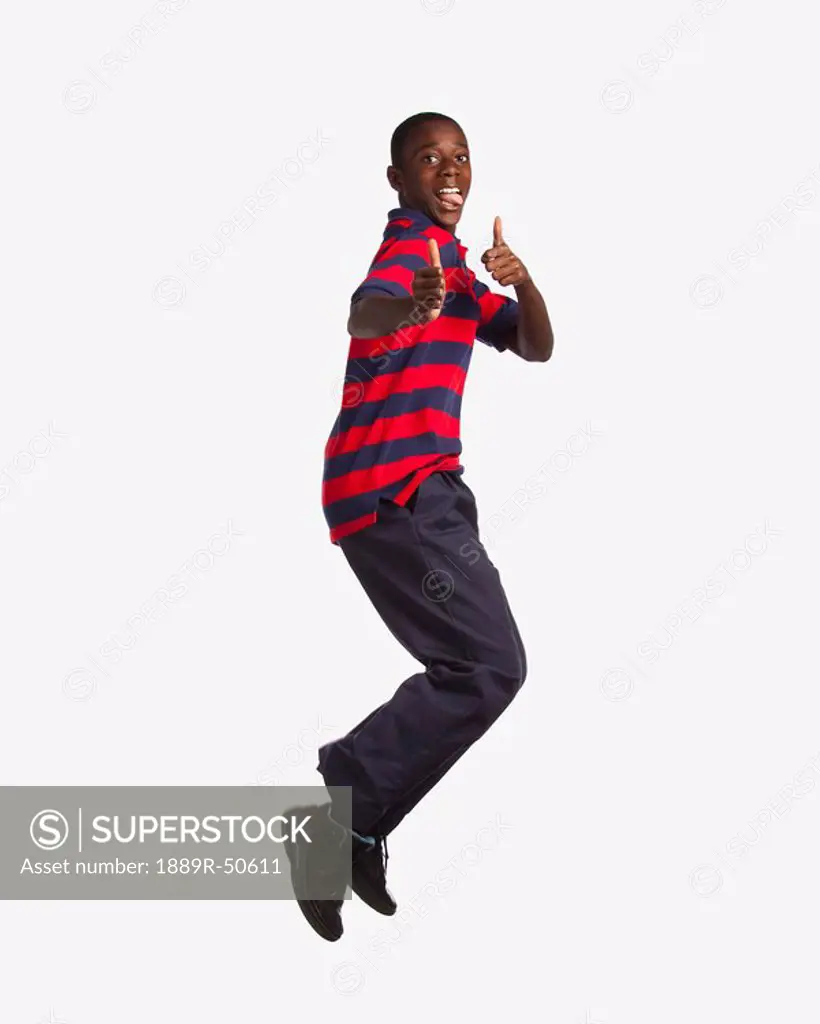 boy jumping and giving the thumbs up