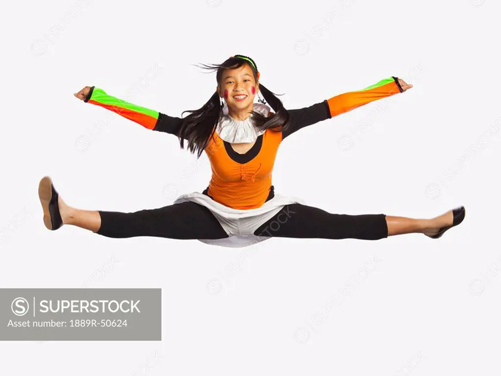 girl jumping with legs and arms outstretched