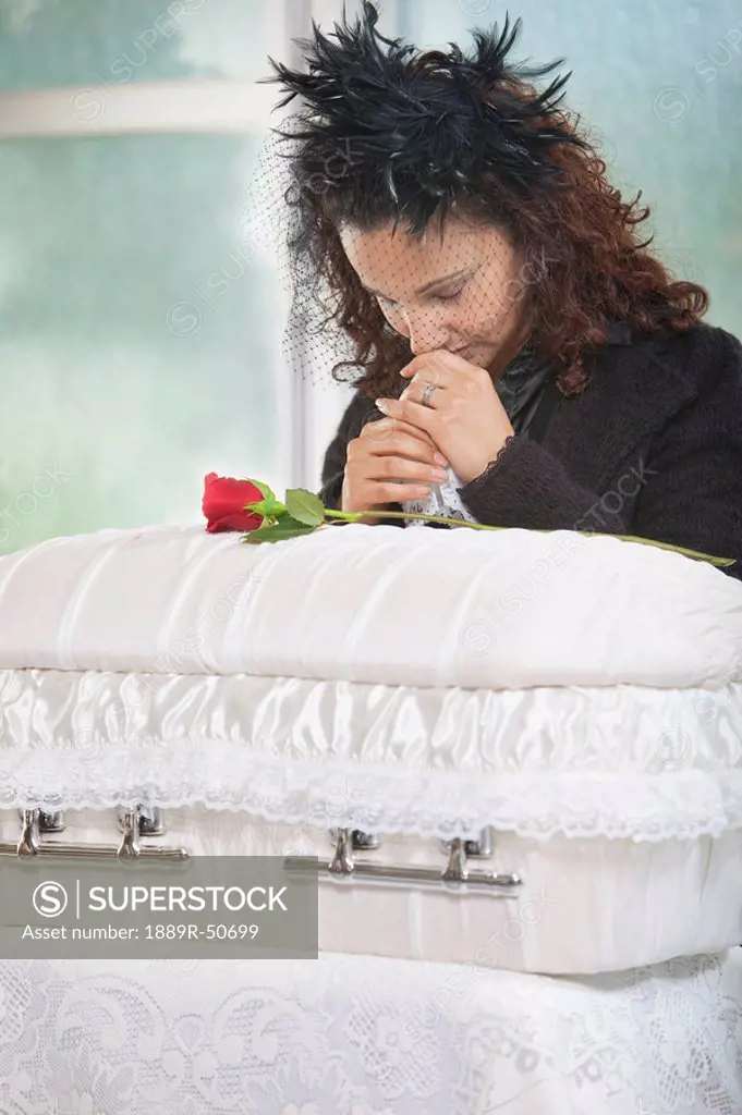 grieving mother with infant´s coffin