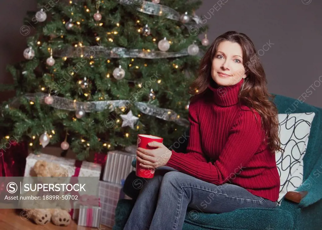 woman sitting by the christmas tree