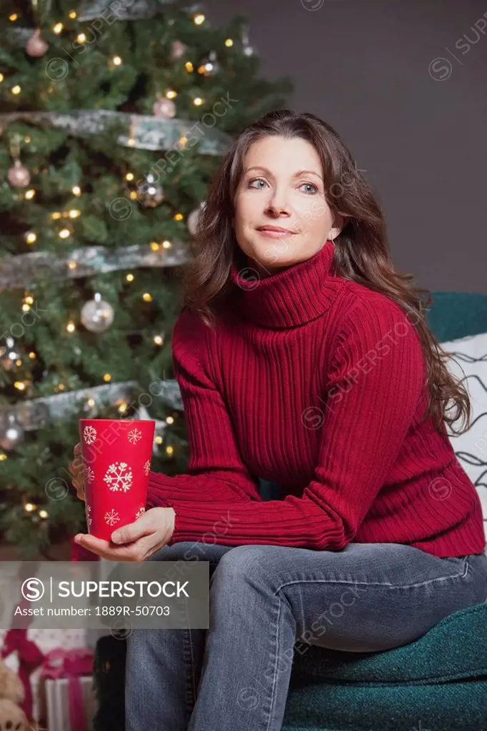 woman sitting by the christmas tree