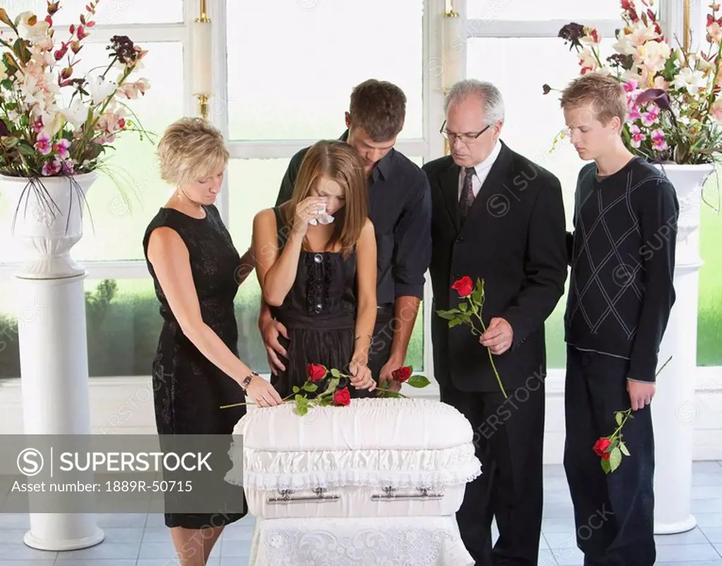 grieving family with an infant´s coffin