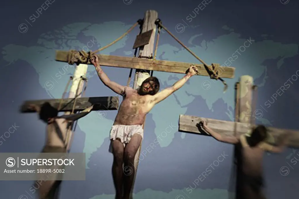 Jesus on cross with two others, map in background