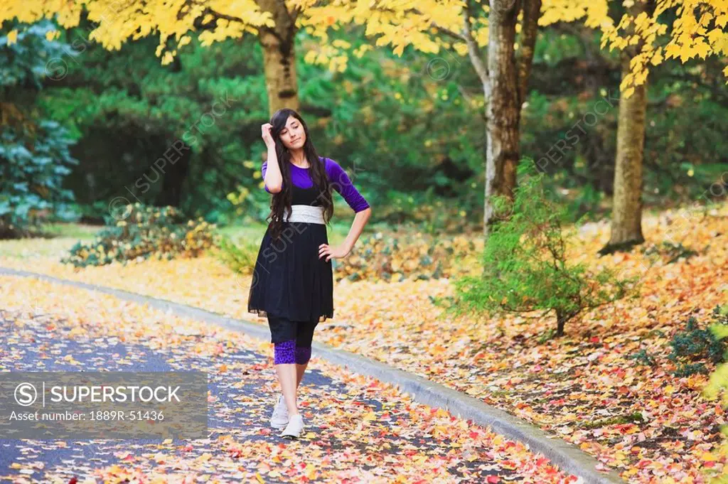 portland, oregon, united states of america, a teenage girl walking down the street in autumn