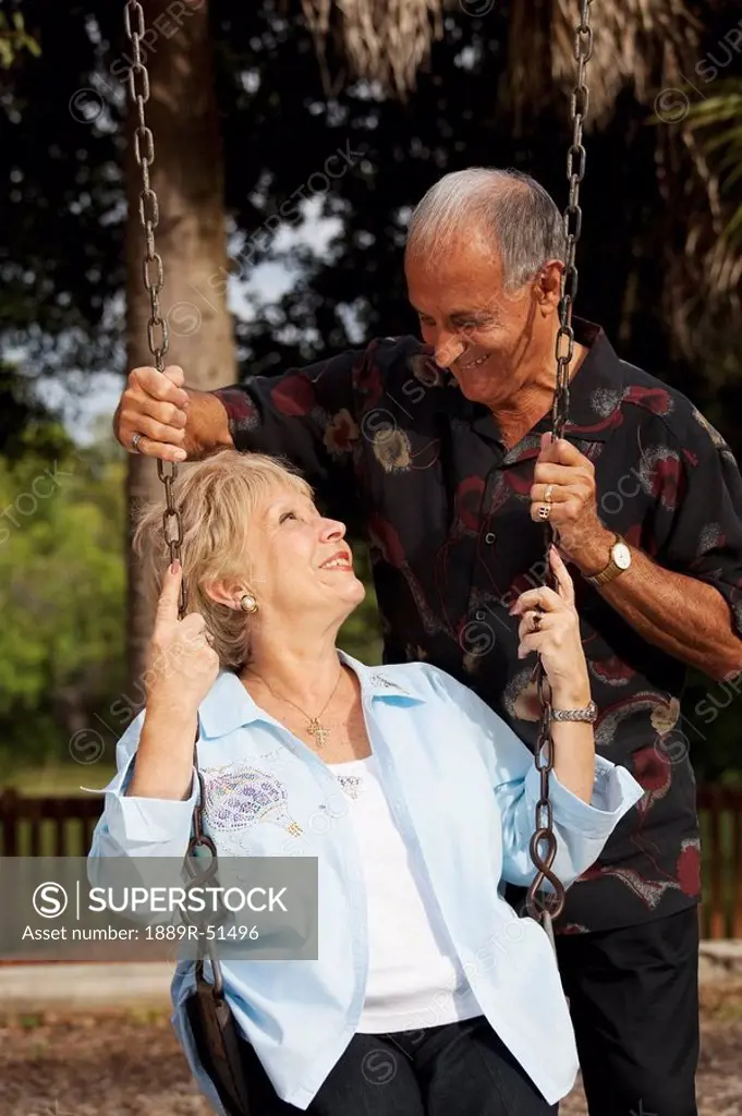 fort lauderdale, florida, united states of america, a married couple with the woman sitting on a swing