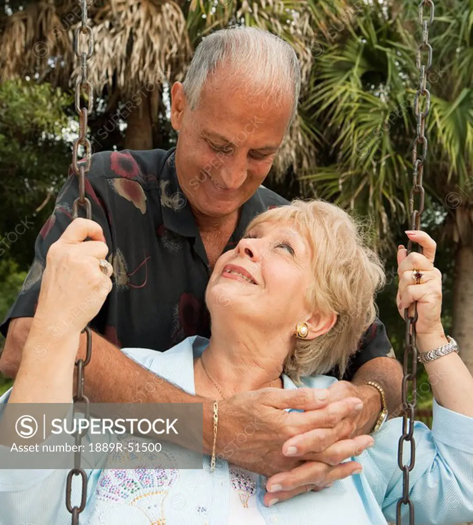 fort lauderdale, florida, united states of america, a couple with the woman sitting on a swing