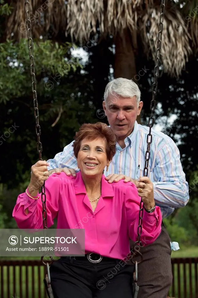 fort lauderdale, florida, united states of america, a couple with the woman sitting on a swing