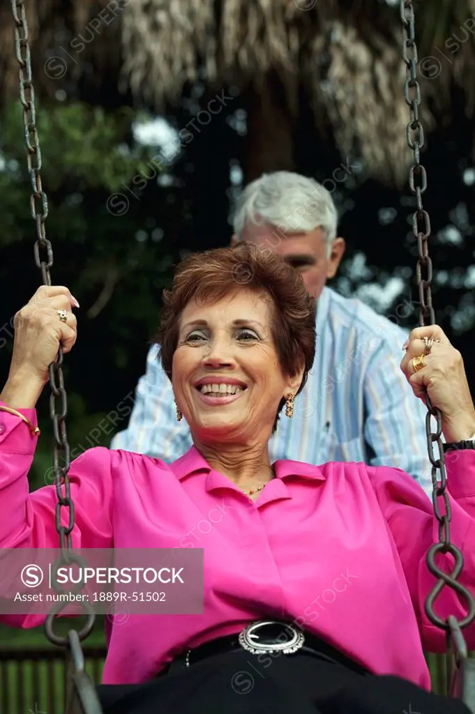 fort lauderdale, florida, united states of america, a man pushing a woman on the swing
