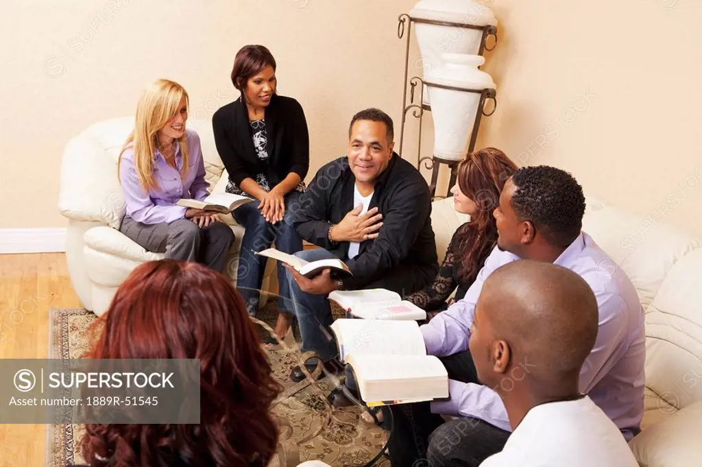 a group of adults in a home bible study