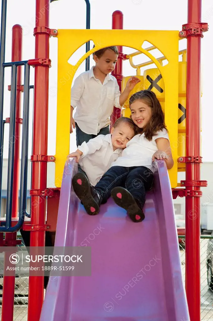three children playing at the playground