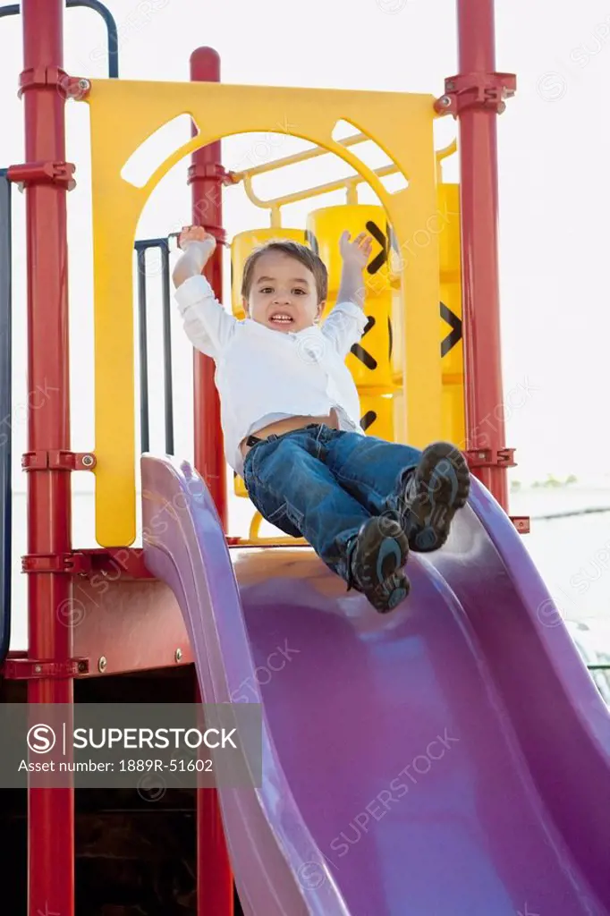 young boy playing at the playground