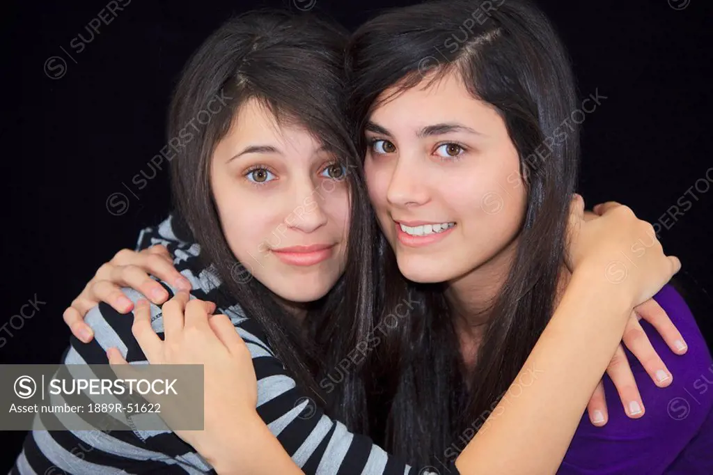 two teenage girls in an embrace