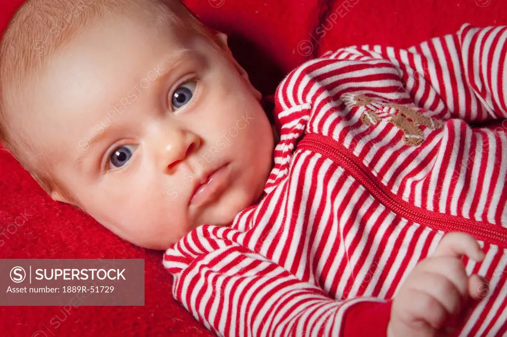 an infant wearing red and white