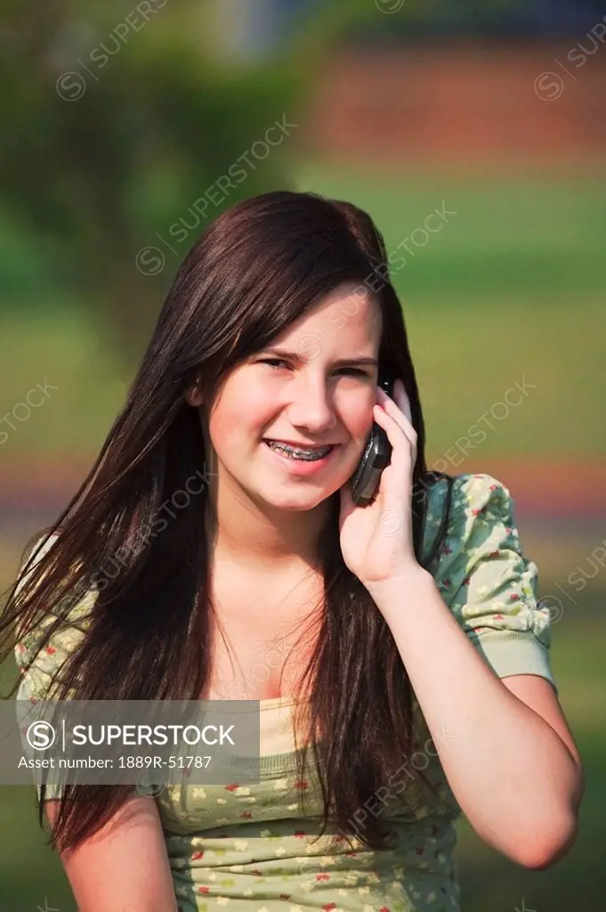 a girl in the park on her cell phone