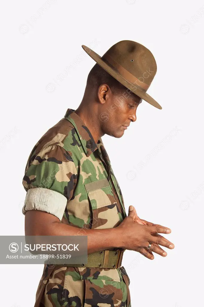 a military man with his head bowed in contemplation