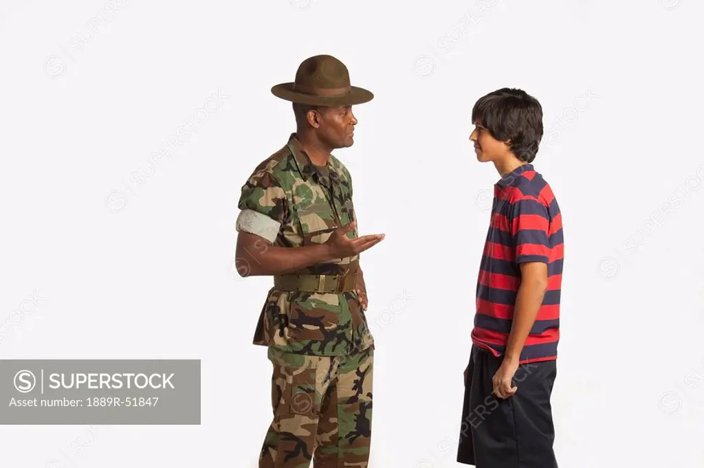 a military man talking to a teenage boy
