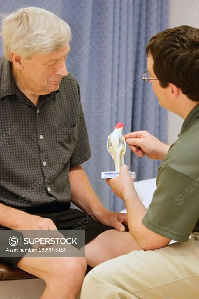 A medical professional explaining a concept to a senior patient