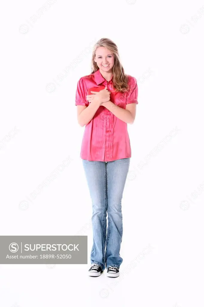 a girl holding a heart to her chest