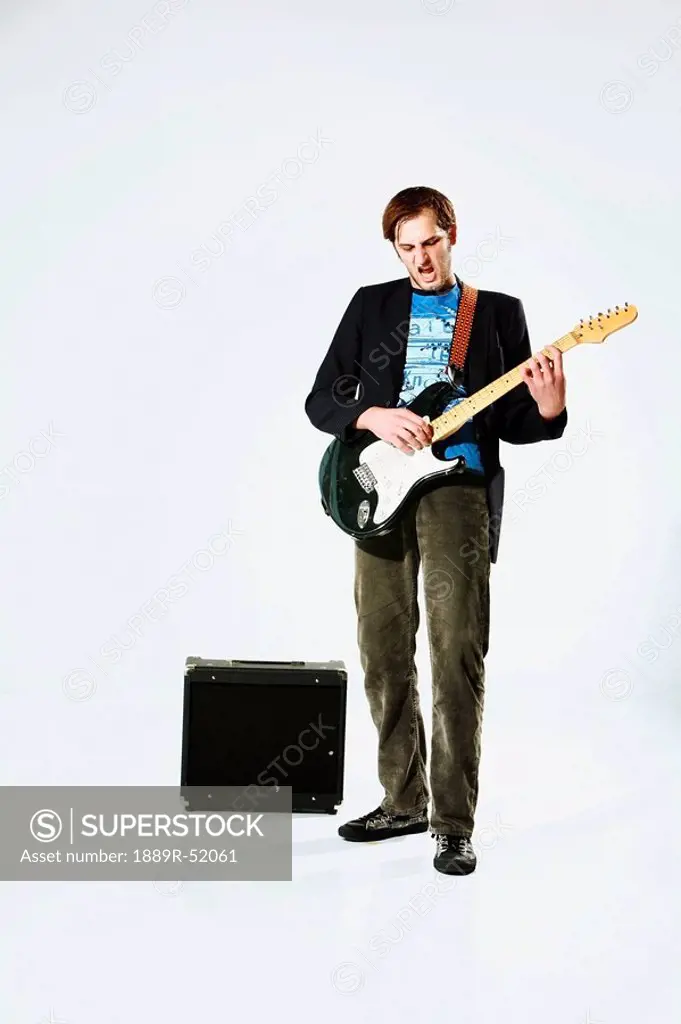 a young man playing an electric guitar